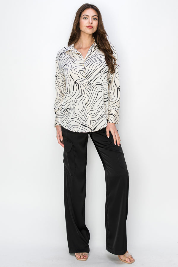 • SKU: T5384 • S-M-L (2-2-2) • Hand wash only • a long-sleeved shirt with a collar, featuring a print of black wavy lines connecting on a cream background. • This print resembles waves or undulating lines. • It's a versatile piece of women's clothing that would complement both dress pants and jeans. HIGH QUALITY & WHOLESALE PRICE W/ ONENMOREUSA.COM