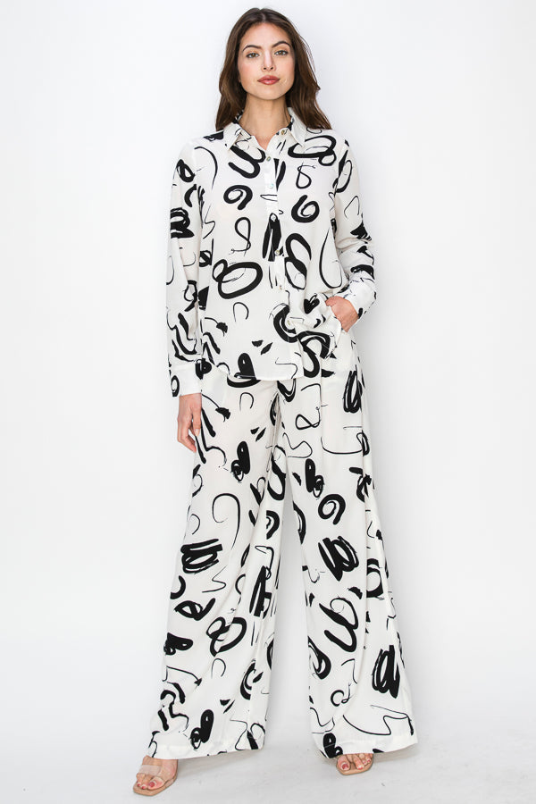 • SKU: T5394, P2231 • S-M-L (2-2-2)                                                                                                                  • Hand wash only •This blouse is characterized by its unique print, which consists of black irregular shapes against a white background. The irregular shapes create an abstract and avant-garde aesthetic, adding an element of intrigue and modernity to the garment. high quality & wholesale price w/ onenmoreusa.com